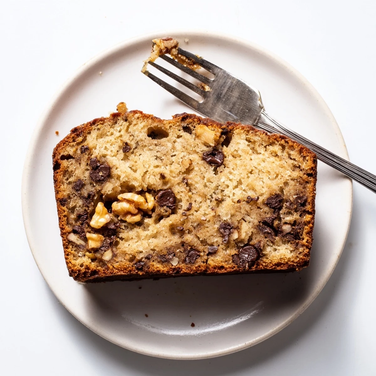 Freshly baked banana bread loaf with sour cream showing tender crumb texture
