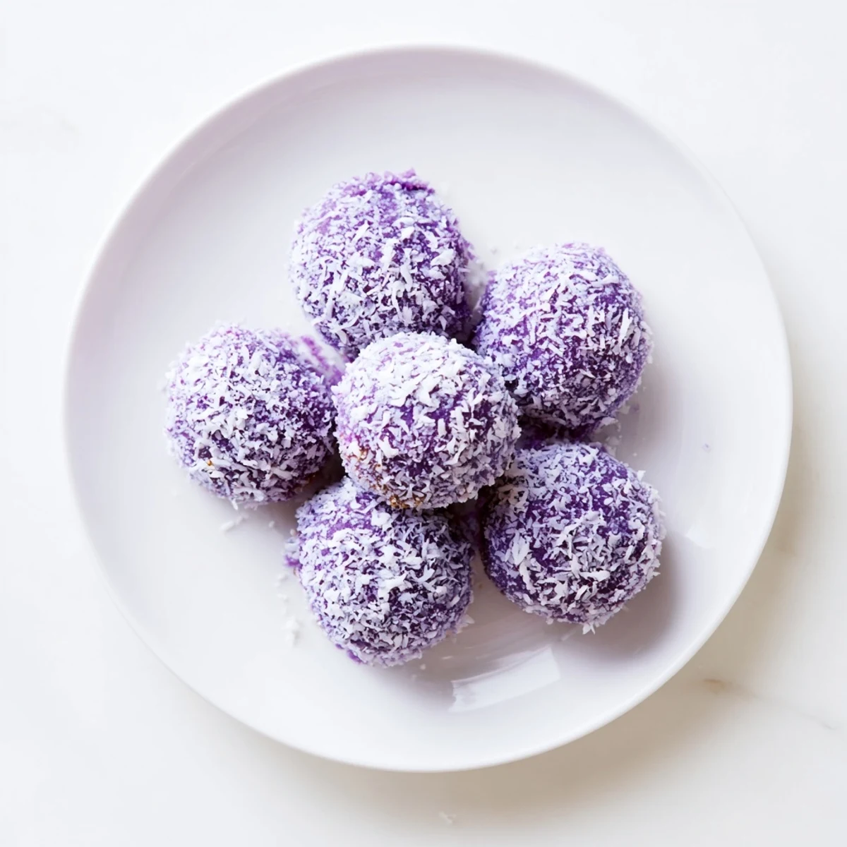 Tender purple ube besito cookies rolled in sweet coconut ready for afternoon tea