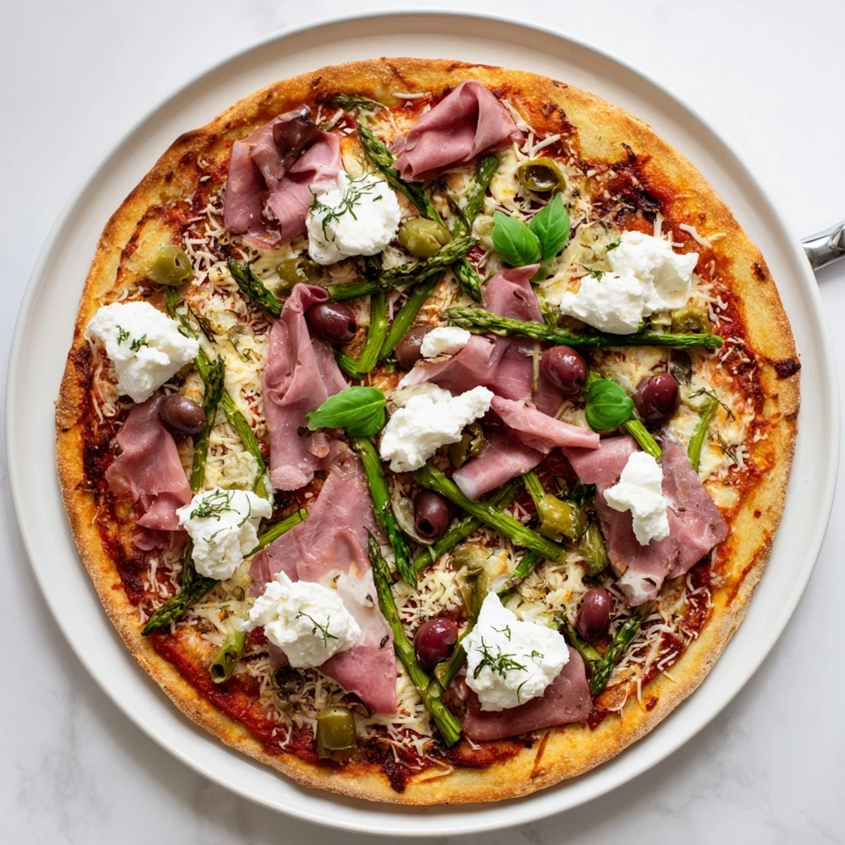 Savory Ham, Olive, Asparagus, and Ricotta Pizza sliced on wooden board with basil