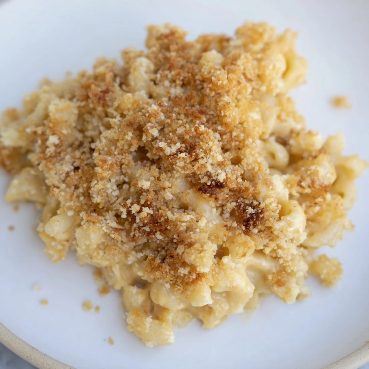 Golden bubbly baked mac and cheese with crispy breadcrumb topping fresh from oven