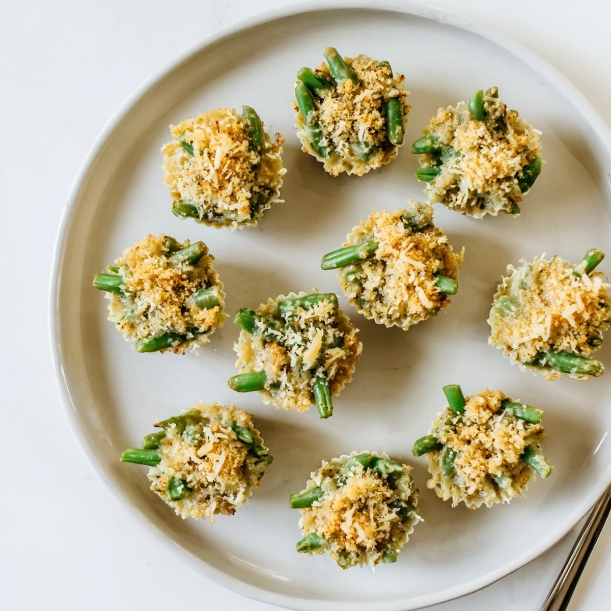 Individual Garlic Parmesan Green Bean Casserole Cups featuring crisp green beans in creamy garlic sauce with melted cheese