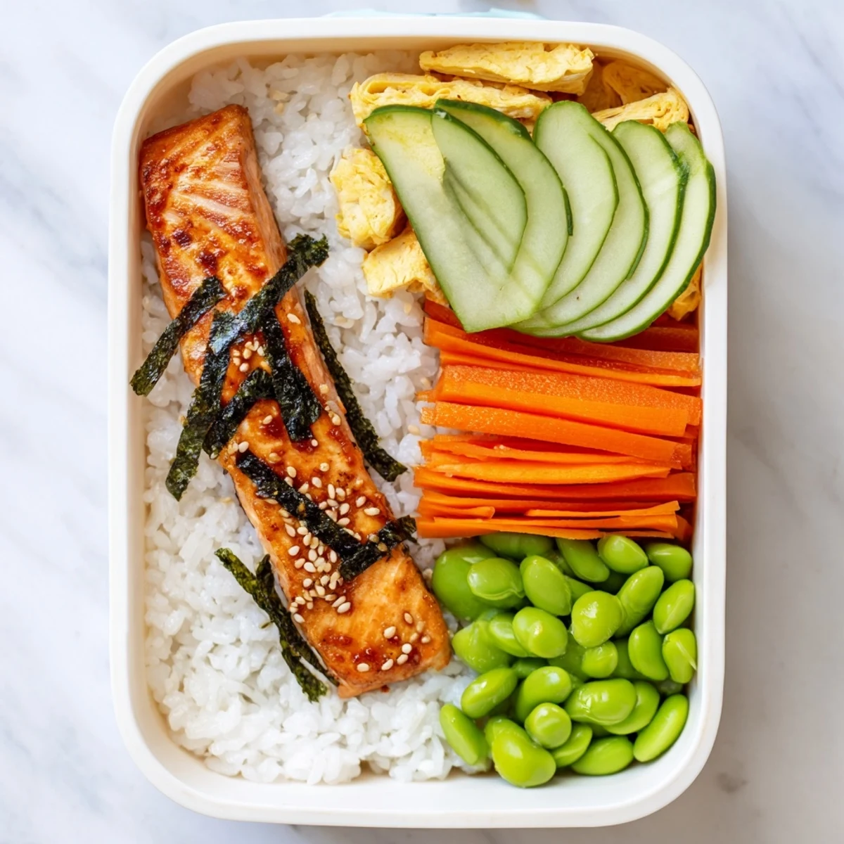 Nourishing Japanese-style breakfast bento featuring golden grilled fish, steamed rice, fresh avocado slices, and seasonal fruit ready for a satisfying morning meal