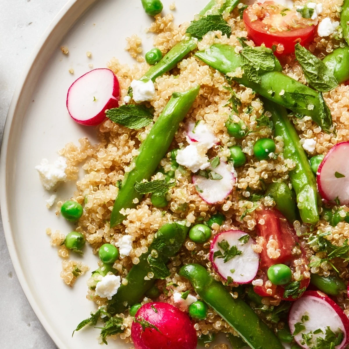 Colorful Spring Vegetable Quinoa Salad featuring bright asparagus radishes and cherry tomatoes