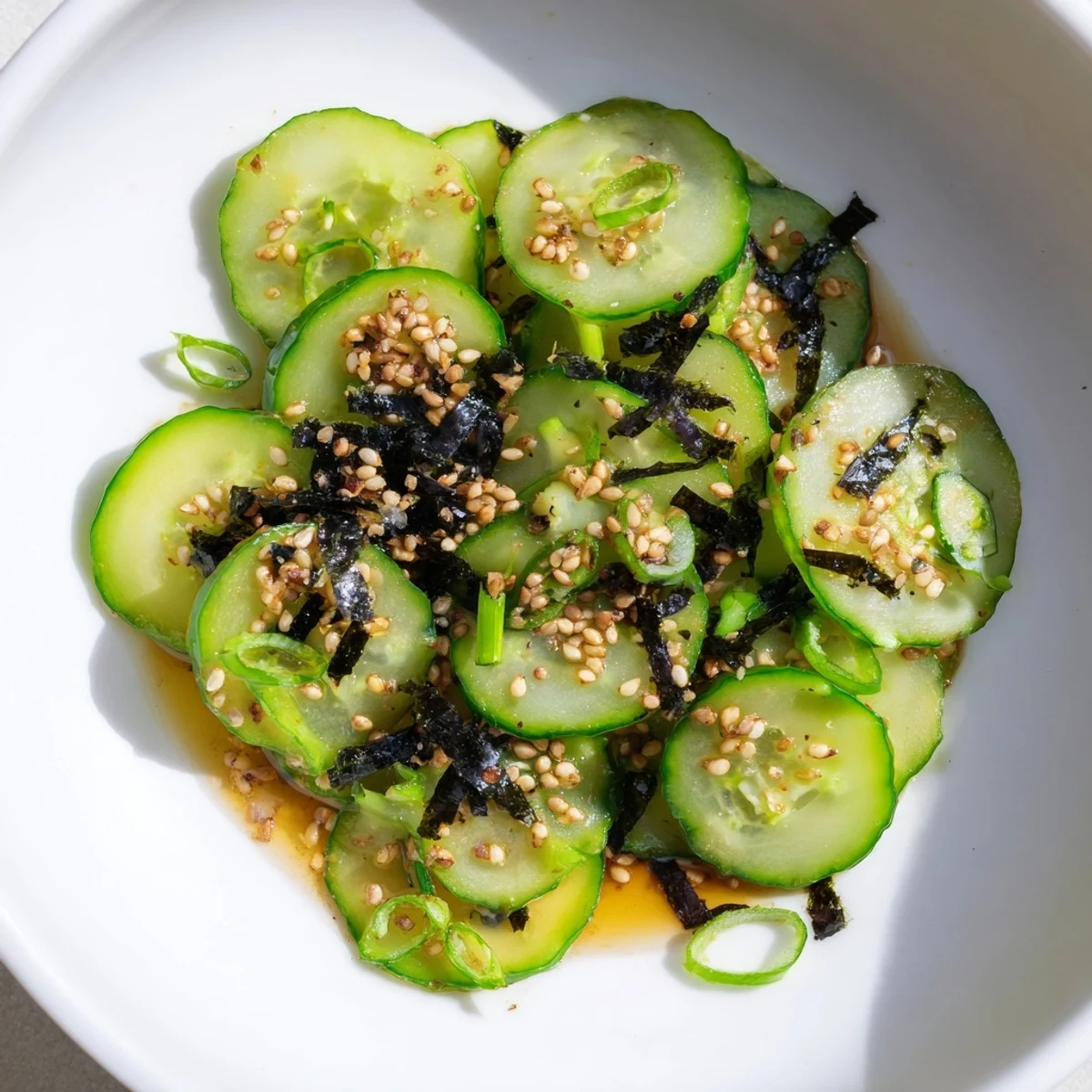 Vibrant sushi cucumber salad topped with sesame seeds creamy avocado and ginger