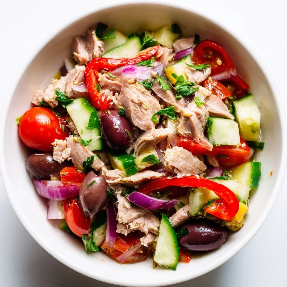 Simple Mediterranean Tuna Salad in a bright bowl with olives and cherry tomatoes