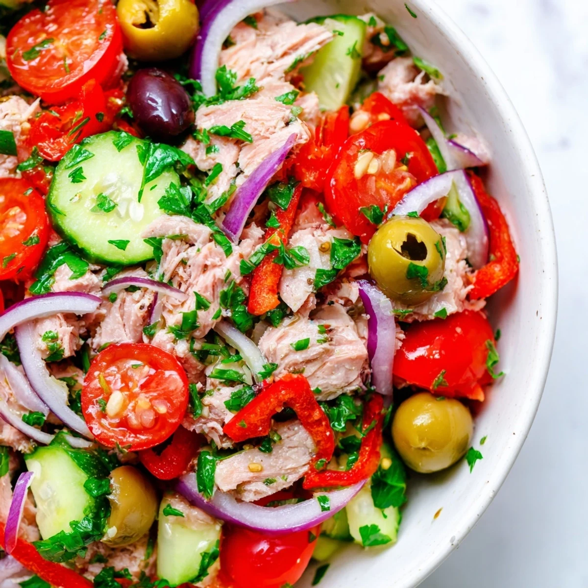 A scoop of Mediterranean Tuna Salad served over crisp greens with lemon dressing