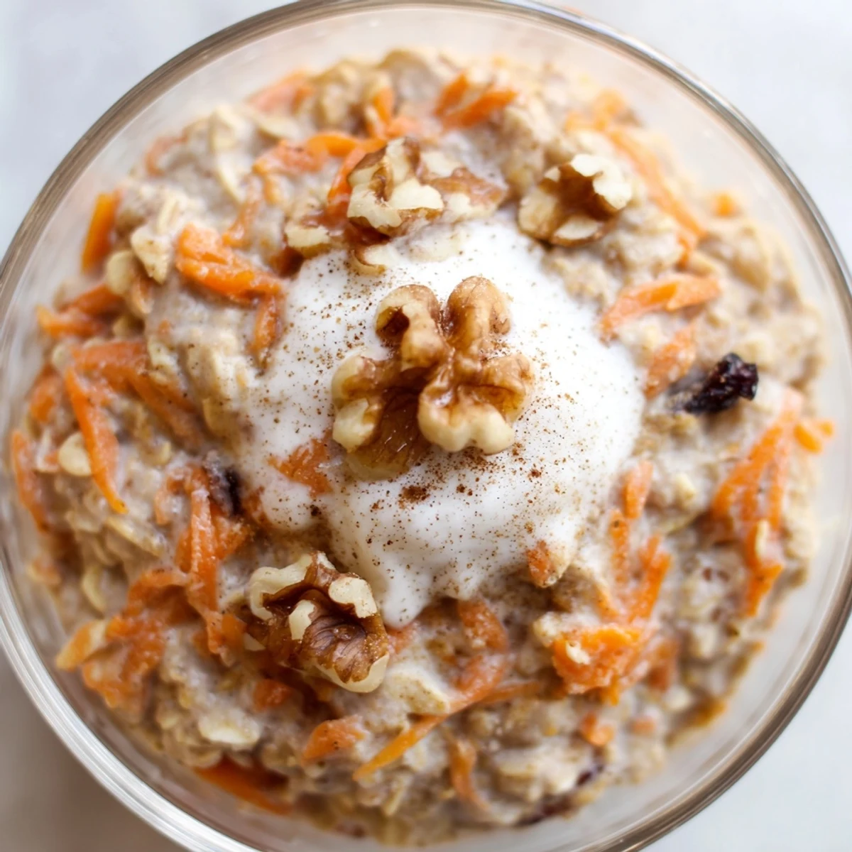 Creamy carrot cake overnight oats topped with crunchy walnuts in a glass jar