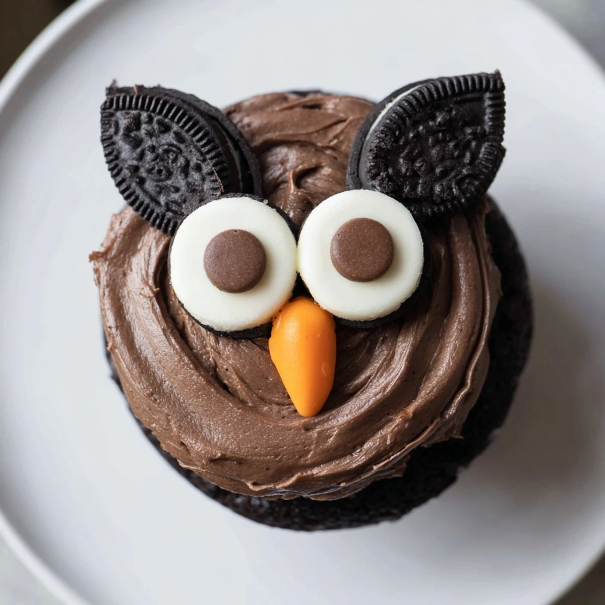 Cute Oreo Owl Cupcakes featuring cookie eyes and orange candy beaks displayed together