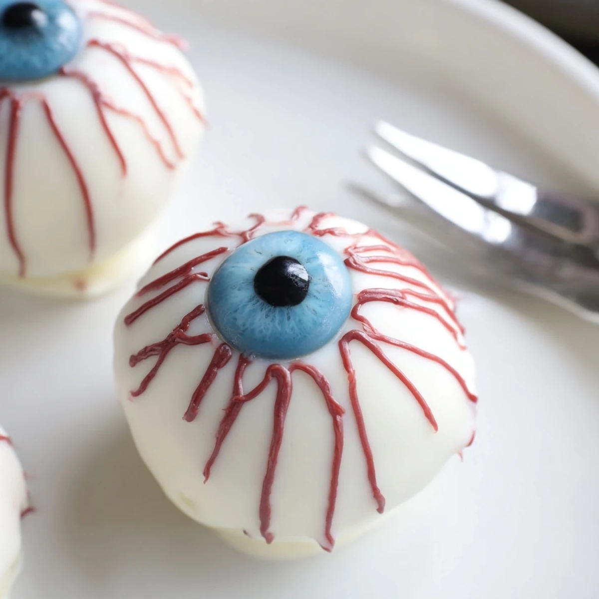 Creepy Halloween Cake Eyeballs coated in smooth white chocolate with detailed veining