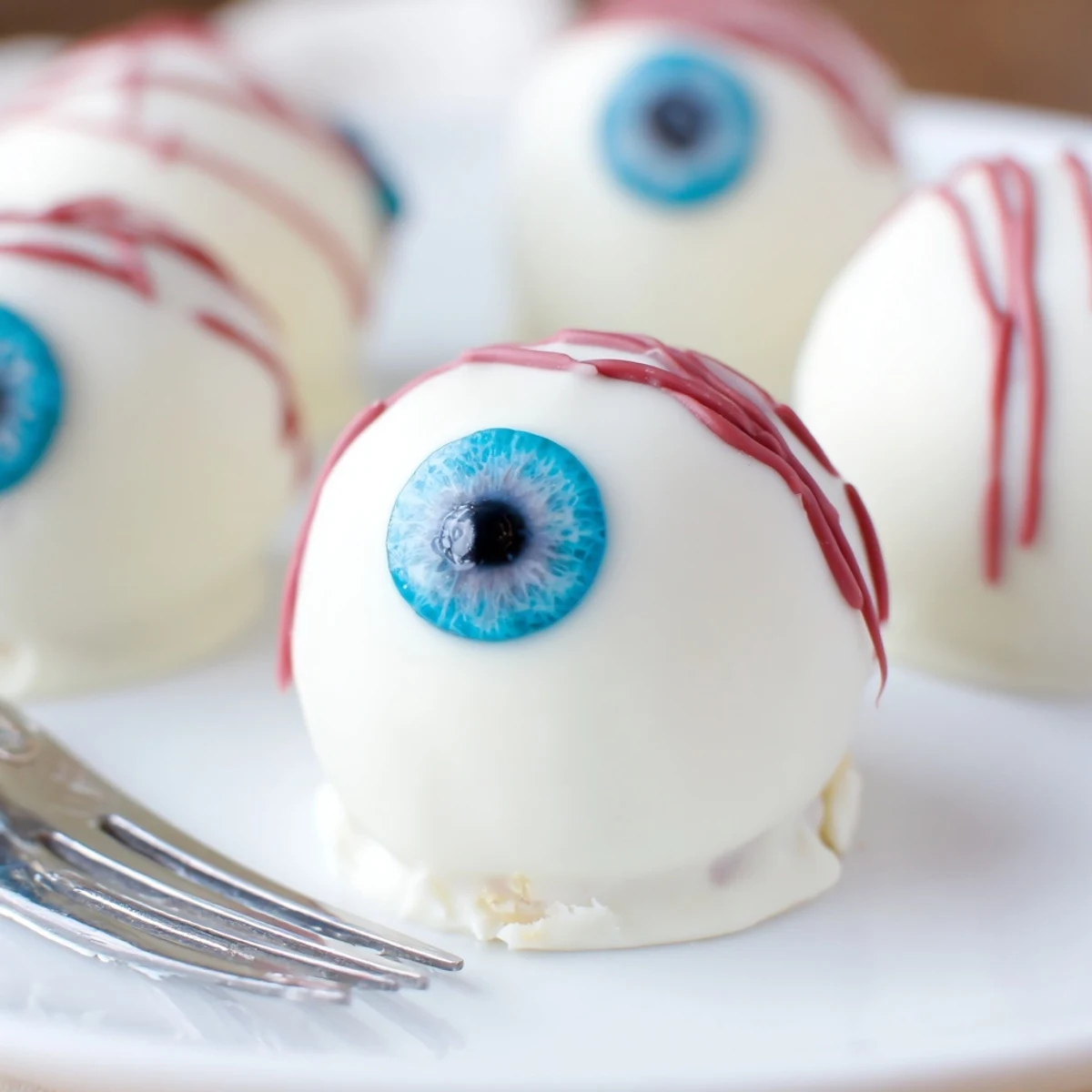 Chilled Halloween Cake Eyeballs arranged on parchment with colorful iris centers displayed