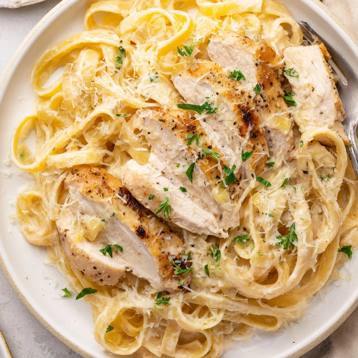Weeknight Creamy Garlic Chicken Pasta tossed with parsley, bright lemon zest