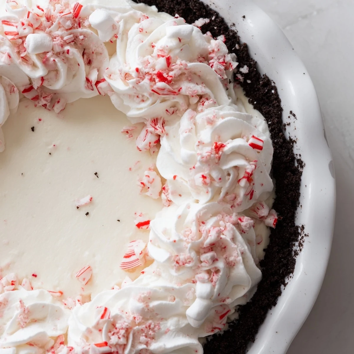 No-bake Candy Cane Pie chilled until set, speckled with crunchy peppermint pieces