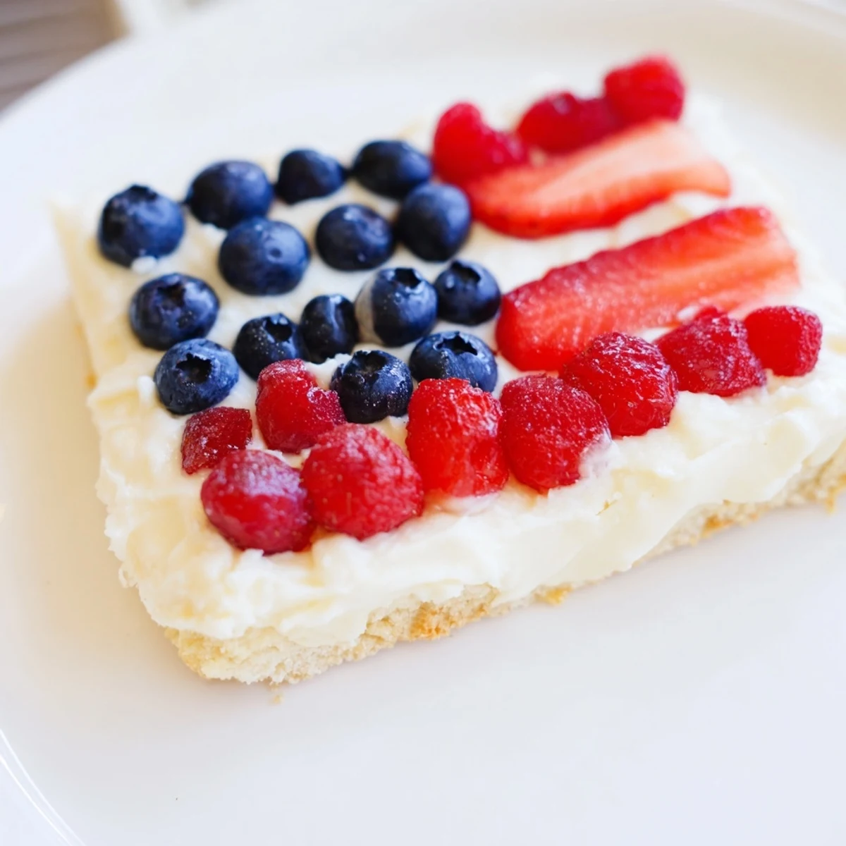 Easy Sugar Cookie Flag Fruit Pizza topped with juicy blueberries and strawberries