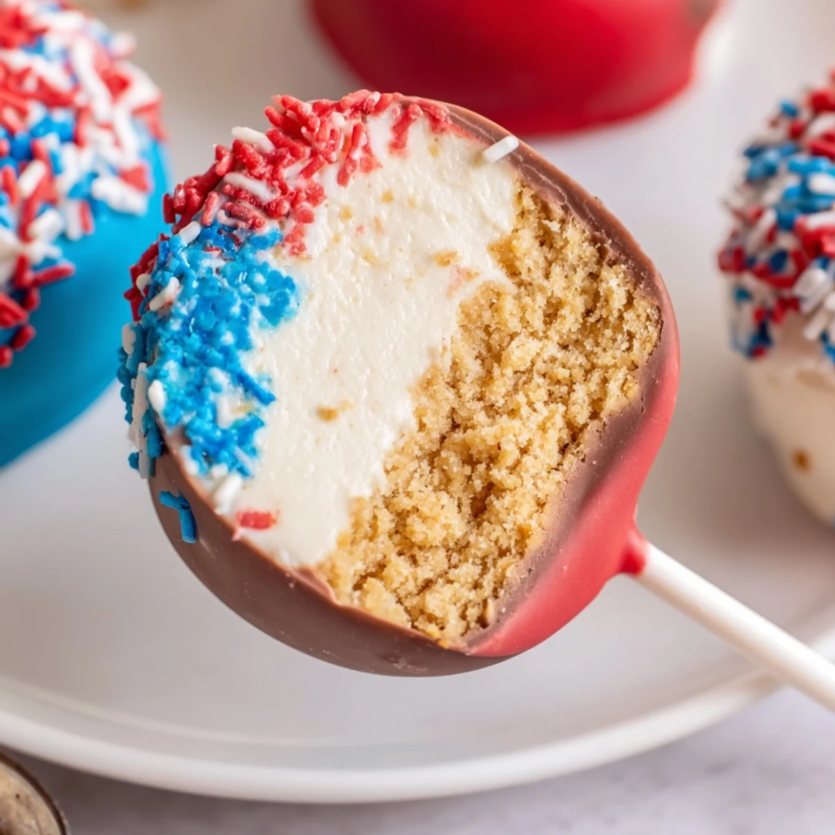 Fourth Of July Star Cheesecake Pops chocolate-dipped, creamy stars topped with patriotic sprinkles