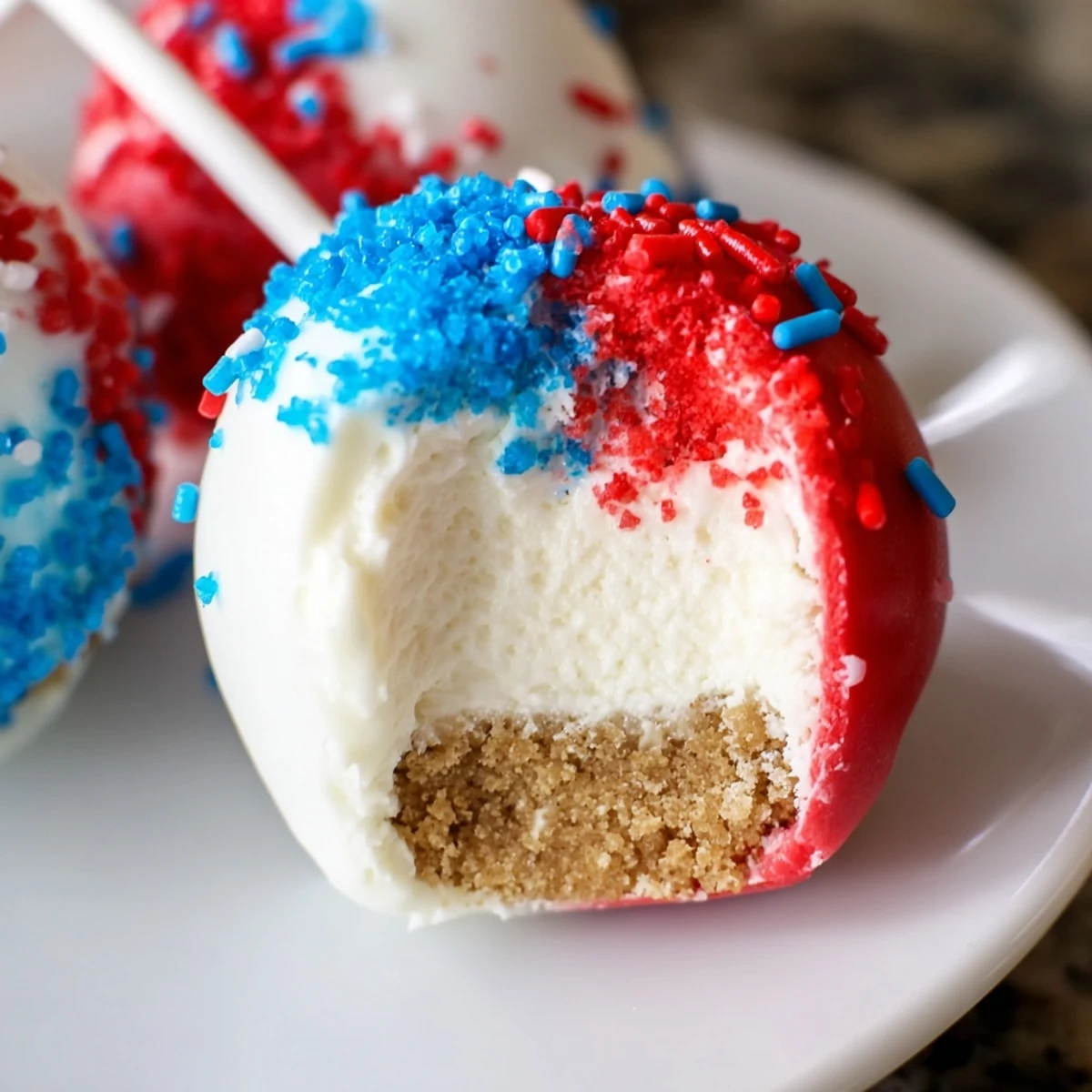 Dipped Fourth Of July Star Cheesecake Pops in red, white, and blue chocolate