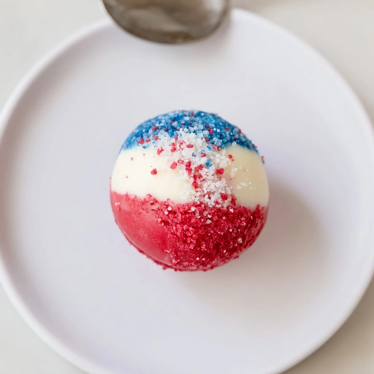 Hands rolling Of July Truffles Creamy And Patriotic before chilling, warm vanilla aroma