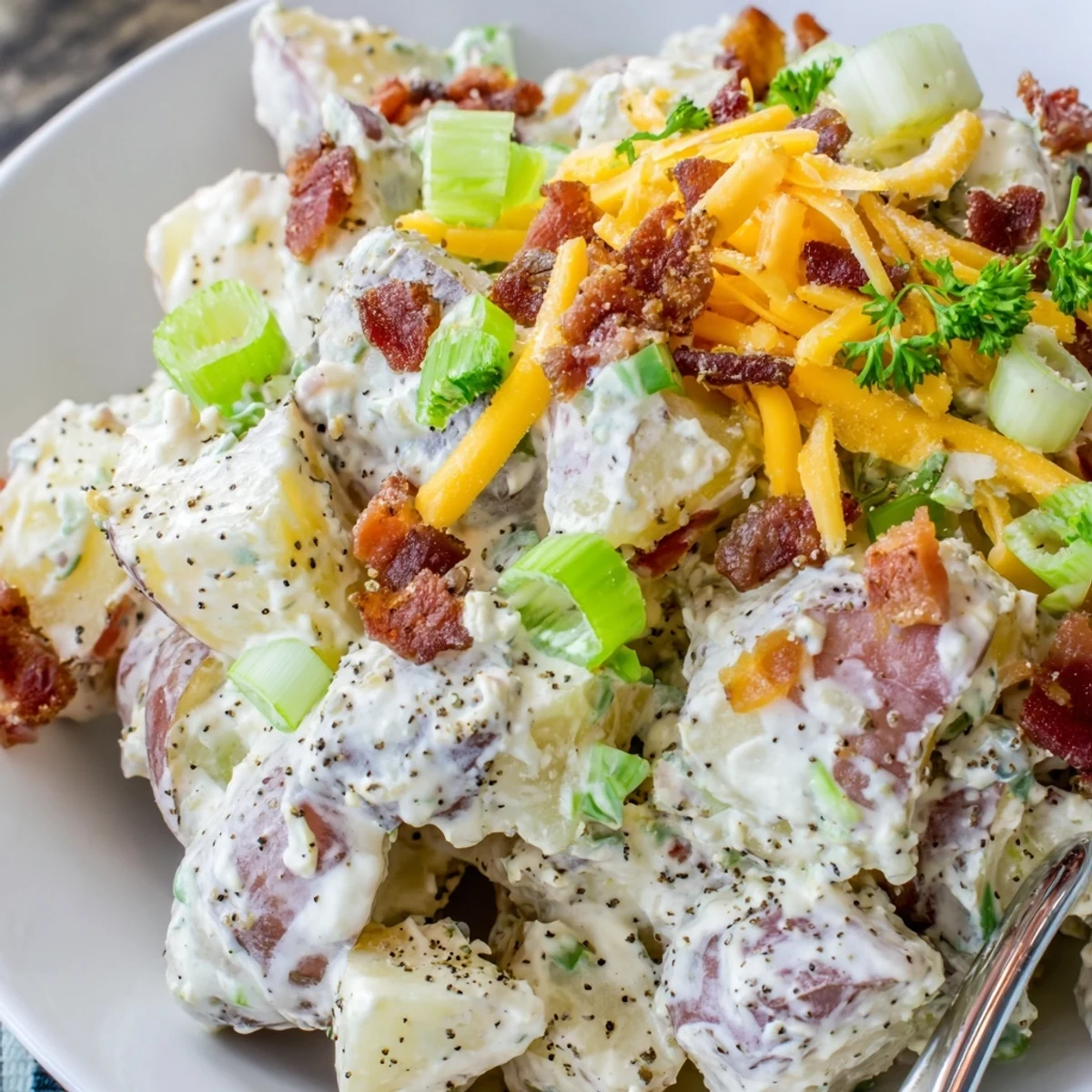 Creamy dressing coats Beef Bacon Loaded Potato Salad, warm and herb-scented