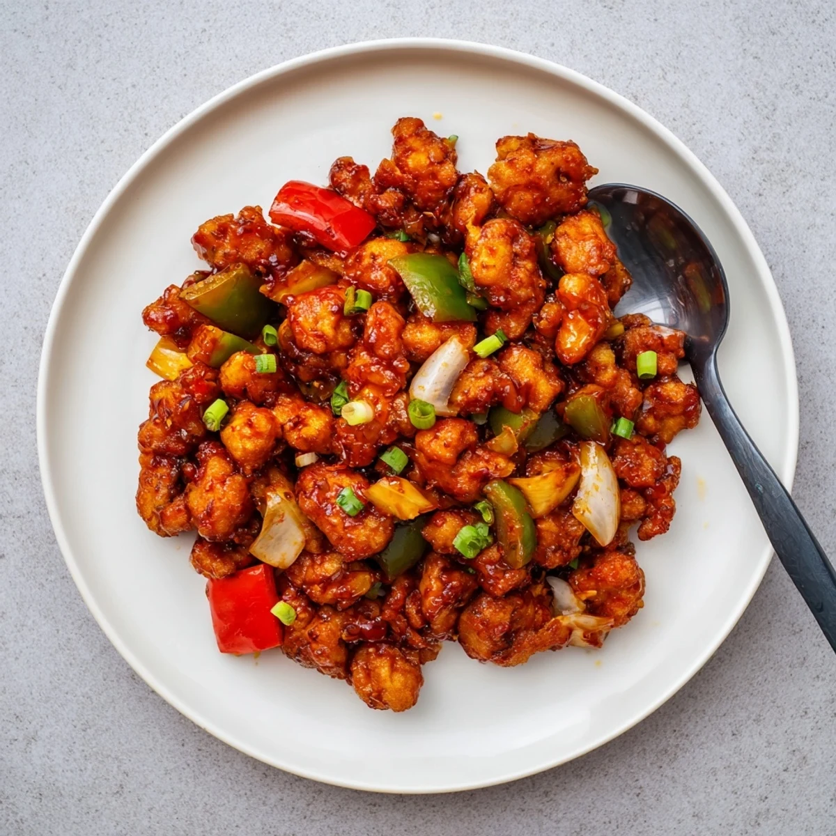 Served hot, Flavorful Chilli Chicken Indo Chinese over fried rice or as appetizer