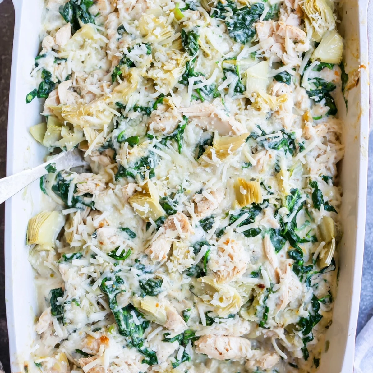 Golden bubbly high protein spinach and artichoke chicken casserole fresh from oven