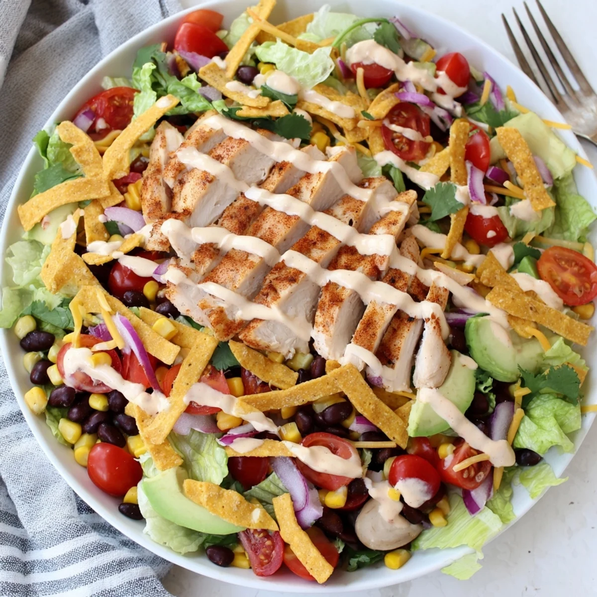 Spicy Southwest Salad With Spicy Ranch Dressing piled with grilled chicken, crunchy tortilla strips