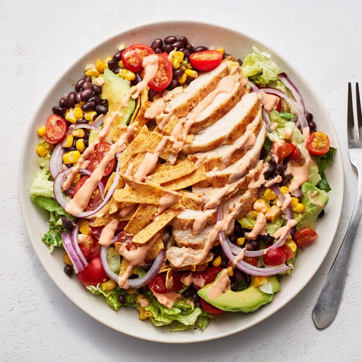 Grilled chicken-topped Spicy Southwest Salad With Spicy Ranch Dressing ready to serve, vivid colors