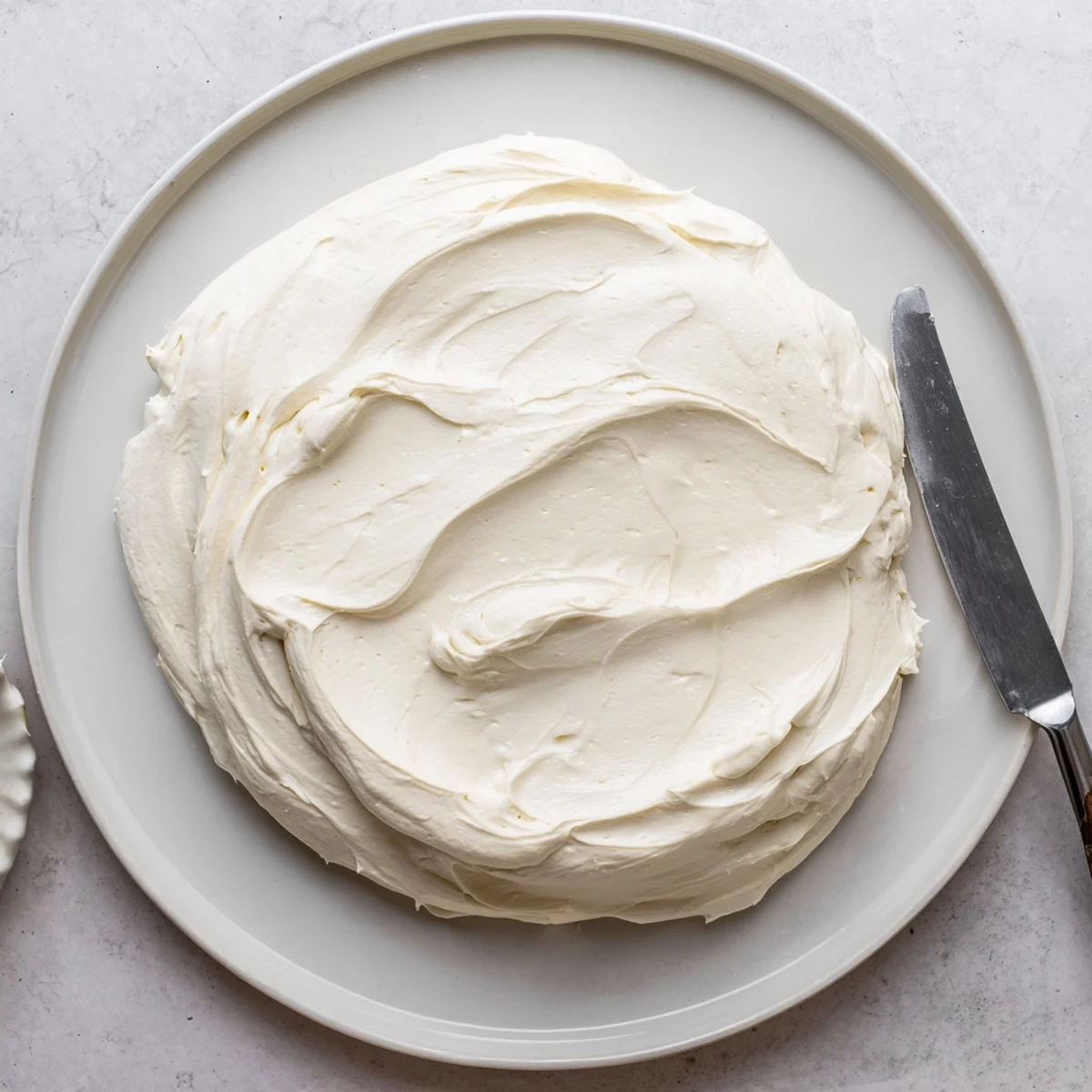 Silky Italian Meringue Buttercream piped into elegant swirls atop golden cupcakes