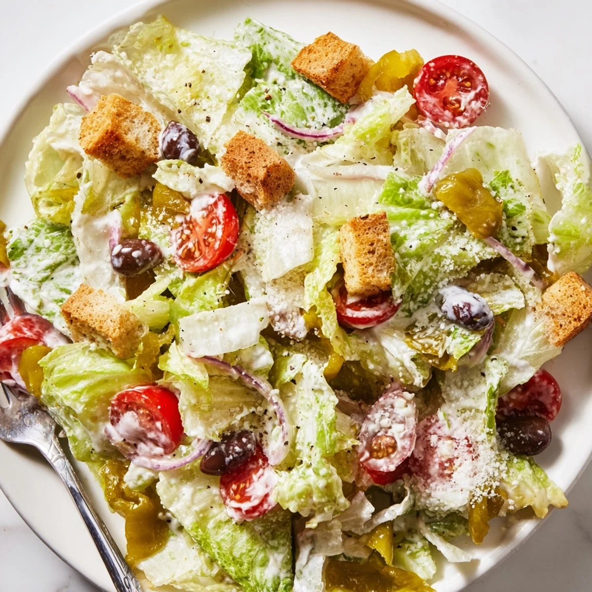 Fresh Olive Garden Salad in a bowl with pepperoncini, croutons, and tangy vinaigrette