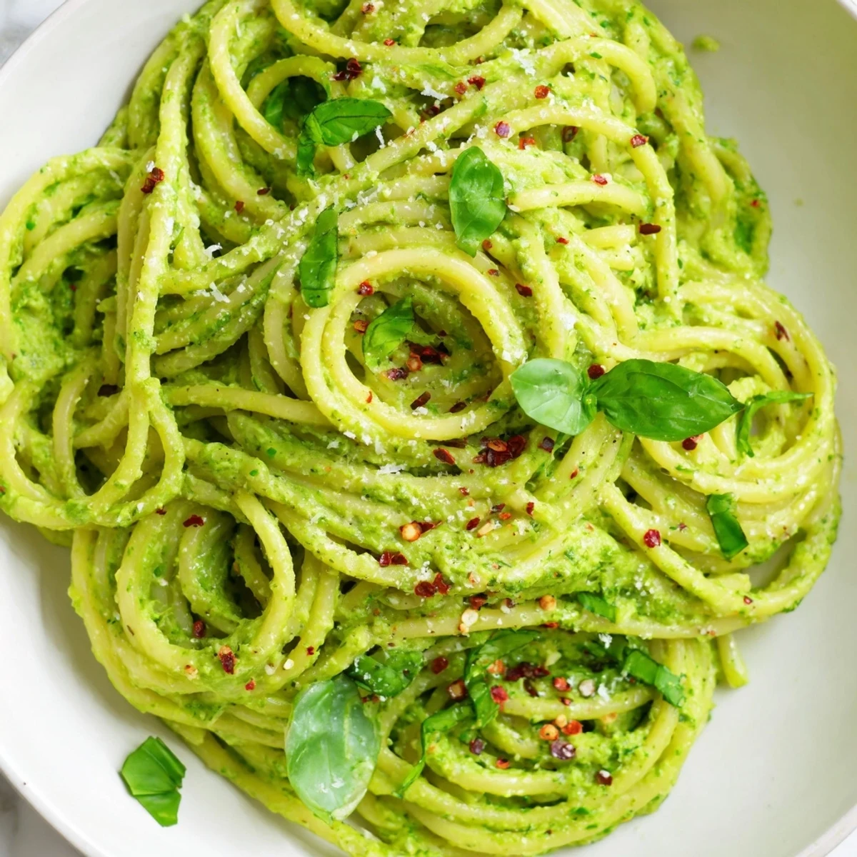 Velvety green goddess pasta sauce served in a white bowl topped with herbs