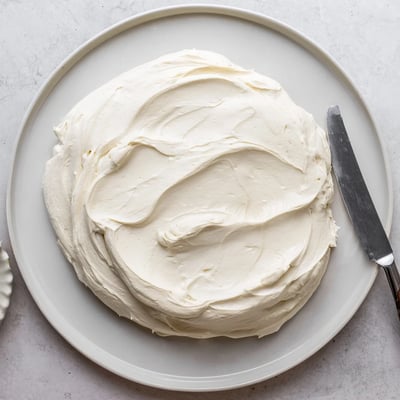 Silky Italian Meringue Buttercream piped into elegant swirls atop golden cupcakes